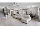 Open-concept living area featuring tile flooring, a ceiling fan, and seamless flow into the kitchen at 2275 Pearl Cider St, Orlando, FL 32824