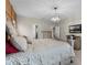 Spacious main bedroom with chandelier, comfortable bed and view into the main bathroom at 2275 Pearl Cider St, Orlando, FL 32824