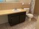 Bathroom showcasing a sink, toilet, vanity with dark cabinets, mirror, and tiled flooring at 228 Everest Pt # 108, Casselberry, FL 32707