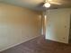 Bedroom featuring neutral paint and brown carpet, with ceiling fan and connecting door at 228 Everest Pt # 108, Casselberry, FL 32707