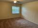 Comfortable bedroom featuring neutral walls, carpet flooring, ceiling fan, and a window at 228 Everest Pt # 108, Casselberry, FL 32707