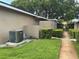 View of the side of home with lush lawn, walkway and maintained bushes at 228 Everest Pt # 108, Casselberry, FL 32707