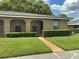 Inviting single-story home with a well-kept lawn leading to the entrance walkway at 228 Everest Pt # 108, Casselberry, FL 32707
