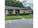 Charming single-story home with well-maintained lawn, complemented by a tree and paved parking at 228 Everest Pt # 108, Casselberry, FL 32707