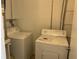 Functional laundry room with a standard top-load washer and front-load dryer at 228 Everest Pt # 108, Casselberry, FL 32707