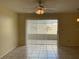 Bright living room with tiled floors, ceiling fan, and sliding glass doors to the outside patio at 228 Everest Pt # 108, Casselberry, FL 32707