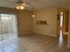 Comfortable living room with tiled floors, ceiling fan and sliding glass door to patio at 228 Everest Pt # 108, Casselberry, FL 32707