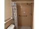 Tiled shower with shower curtain and a mounted shower head with soap dish and installed safety bar at 228 Everest Pt # 108, Casselberry, FL 32707