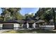 Charming single-story home featuring a well-manicured lawn and a two-car garage at 2313 Park Village Pl, Apopka, FL 32712