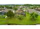 An aerial view of a home, its backyard pool and patio, and the lush trees around it at 2360 Brewerton Ln, Orlando, FL 32824