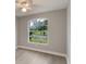 Bright bedroom with hardwood floors, a ceiling fan, and a large window with a view at 2360 Brewerton Ln, Orlando, FL 32824