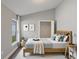 This staged bedroom has a walk-in closet, neutral paint, and a big bright window at 2360 Brewerton Ln, Orlando, FL 32824