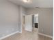 This bedroom features a walk-in closet and an adjacent bathroom with brown cabinets at 2360 Brewerton Ln, Orlando, FL 32824