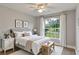 Staged bedroom with hardwood floors, a ceiling fan, a large window, and neutral-toned decor at 2360 Brewerton Ln, Orlando, FL 32824