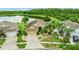 Inviting single-story home with lush landscaping, circular driveway, and scenic lake views in a tranquil neighborhood at 2360 Brewerton Ln, Orlando, FL 32824