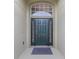 Inviting front entrance featuring a dark green door with sidelights and transom window for natural light at 2360 Brewerton Ln, Orlando, FL 32824
