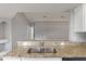 A kitchen with granite countertops, stainless steel sink and view into the living area at 2360 Brewerton Ln, Orlando, FL 32824
