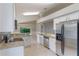 Well-lit kitchen boasts stainless steel appliances, granite counters, and a view of the pool at 2360 Brewerton Ln, Orlando, FL 32824