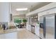 Updated kitchen with stainless steel appliances, granite counters, and view of dining room at 2360 Brewerton Ln, Orlando, FL 32824