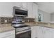 Kitchen showcasing stainless steel appliances, granite counters, and a tile backsplash at 2360 Brewerton Ln, Orlando, FL 32824