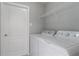 This laundry room features a washer, dryer, and handy shelving at 2360 Brewerton Ln, Orlando, FL 32824