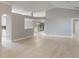 Open-concept living space with sleek hardwood floors and modern architectural details to adjoining rooms at 2360 Brewerton Ln, Orlando, FL 32824