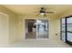 Covered outdoor patio showing open sliding glass doors to view the interior and screened door to pool at 2360 Brewerton Ln, Orlando, FL 32824