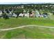 This aerial view highlights the neighborhood's houses and golf course at 2362 Prairie Dunes, Clermont, FL 34711