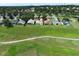 This aerial view highlights the neighborhood's houses and golf course at 2362 Prairie Dunes, Clermont, FL 34711