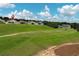 An aerial view from the golf course, showcasing the house on the hill at 2362 Prairie Dunes, Clermont, FL 34711