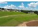 An aerial view from the golf course, showcasing the house on the hill at 2362 Prairie Dunes, Clermont, FL 34711