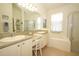 Bright Primary bathroom with double sinks, vanity area, tub, and a separate shower at 2362 Prairie Dunes, Clermont, FL 34711