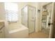 Relaxing bathroom with a separate shower and tub, offering a spa-like experience at 2362 Prairie Dunes, Clermont, FL 34711