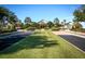 Beautifully landscaped entrance to the clubhouse with palm trees and manicured lawns at 2362 Prairie Dunes, Clermont, FL 34711