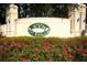 Landscaped entrance to Summit Greens with rose bushes and a large community sign at 2362 Prairie Dunes, Clermont, FL 34711