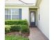 Charming front entrance with decorative glass door and brick pathway at 2362 Prairie Dunes, Clermont, FL 34711