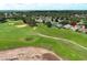 Aerial view of golf course with sand traps near luxury homes in a well-manicured community at 2362 Prairie Dunes, Clermont, FL 34711