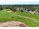 Aerial view of golf course with sand traps near luxury homes in a well-manicured community at 2362 Prairie Dunes, Clermont, FL 34711