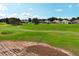 Scenic view of a golf course and community homes, with a partly cloudy sky above at 2362 Prairie Dunes, Clermont, FL 34711