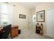 Home office space with a desk, shelves, neutral carpet, and natural light at 2362 Prairie Dunes, Clermont, FL 34711