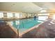 Bright indoor pool with brick surround, hand rails, and large windows for natural light at 2362 Prairie Dunes, Clermont, FL 34711