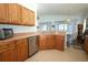 Stylish kitchen with stainless steel dishwasher, ample cabinet space, and tile flooring at 2362 Prairie Dunes, Clermont, FL 34711