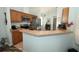 Well-equipped kitchen with stainless steel appliances and a breakfast bar at 2362 Prairie Dunes, Clermont, FL 34711