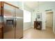 Bright kitchen area with stainless steel refrigerator and natural light from a large window at 2362 Prairie Dunes, Clermont, FL 34711
