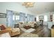 Spacious living room featuring wood floors and access to the dining area at 2362 Prairie Dunes, Clermont, FL 34711