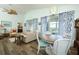 Spacious living and dining area with bright, natural light, wood floors, and stylish furnishings at 2362 Prairie Dunes, Clermont, FL 34711