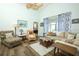 Cozy living room featuring a ceiling fan and sliding glass doors to the outdoors at 2362 Prairie Dunes, Clermont, FL 34711