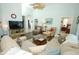 Bright living room with wood flooring, vaulted ceiling, and comfortable seating at 2362 Prairie Dunes, Clermont, FL 34711