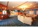 Spacious clubhouse lounge with comfortable seating, bar, and library at 2362 Prairie Dunes, Clermont, FL 34711