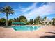 Resort-style outdoor pool with palm trees, gazebo, and ample lounge seating at 2362 Prairie Dunes, Clermont, FL 34711